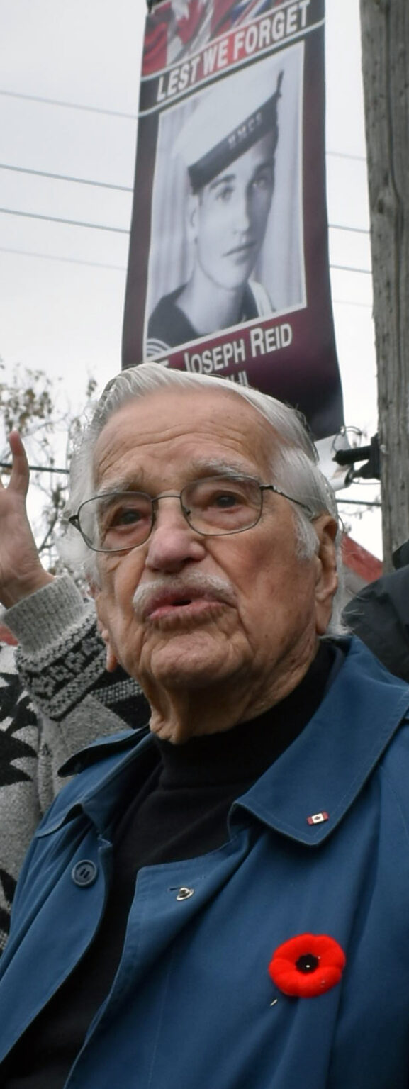 <p>WWII Royal Canadian Navy veteran Joe Reid with his service photo in the background. (Jason Parks/Gazette Staff)</p>

