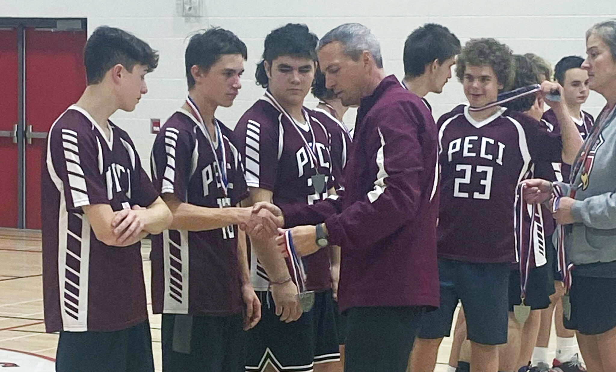 <p>Panthers head coach Andrew Holmes presents COSSA silver medals to his team in Haliburton on Thursday. (Submitted Photo)</p>
