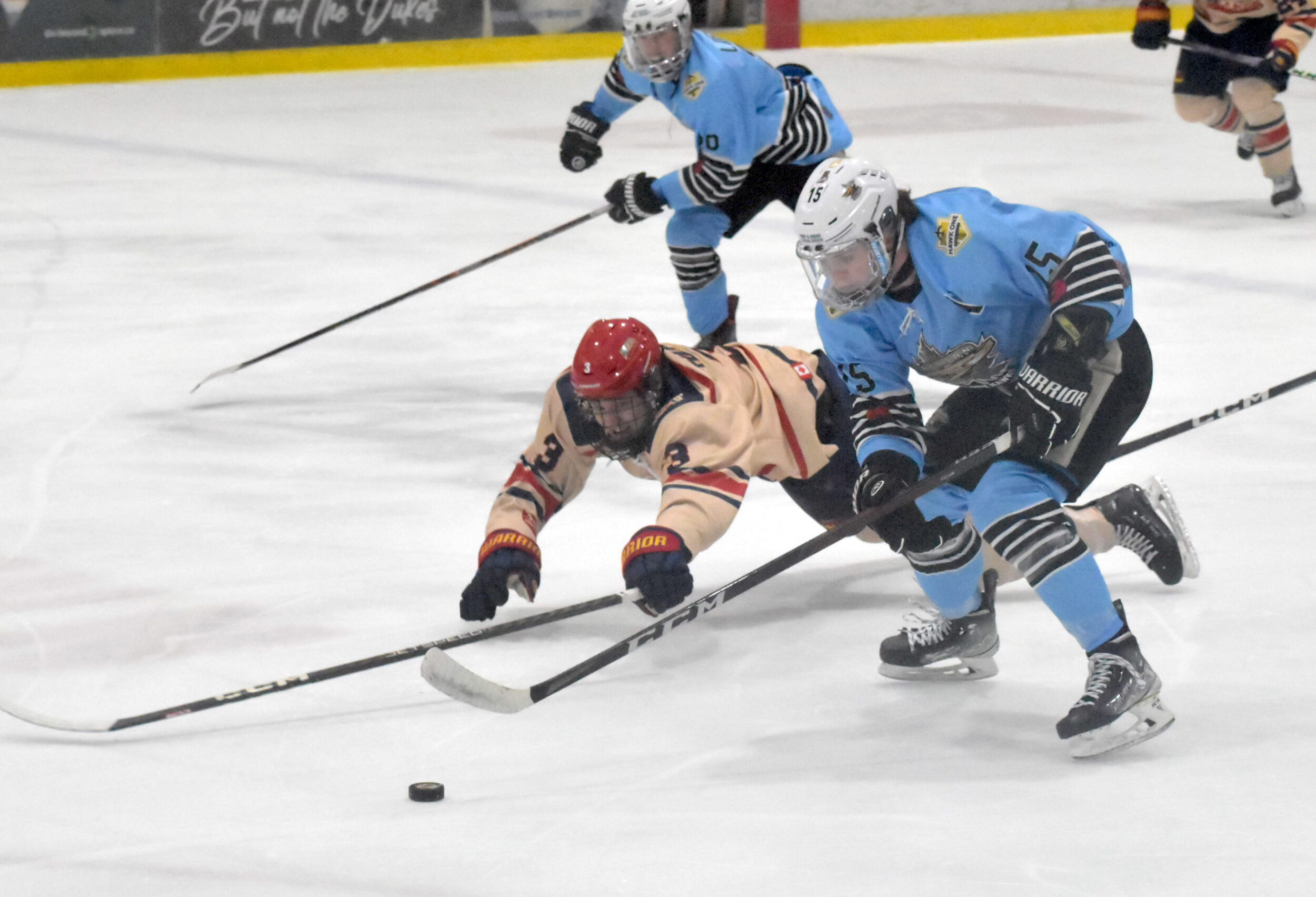 <p>Dukes defender Josh Rumolo reaches out to whack the puck of the stick of the attacking Owen Wilsom in the second period of Friday’s game. (Jason Parks/Gazette Staff)</p>
