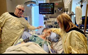 <p>Bill and Heather Insley with the person purported to be their son at the Montfort Hospital in Ottawa. (Insley family photo)</p>
