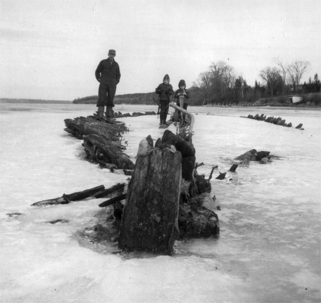 <p>The timbers of the schooner Olivia in Young’s Cove, Picton Harbour, January 1967 (Photo courtesy of Naval Marine Archive, Willis Metcalfe fonds)</p>
