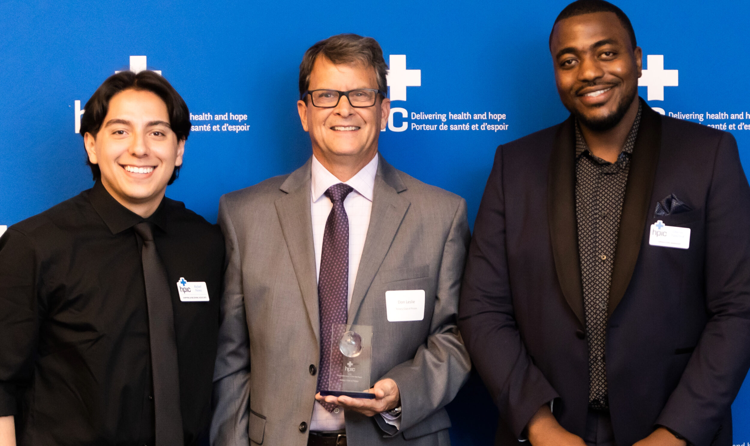 <p>Health Partners International of Canada  Shipping and Receiving Associate (Left) Rafael Nunez and Operations Manager (Right) Charles Van-Dyck flank Rotary Club of Picton President Don Leslie at the 2024 HPIC awards gala. (Supplied Photo)</p>
