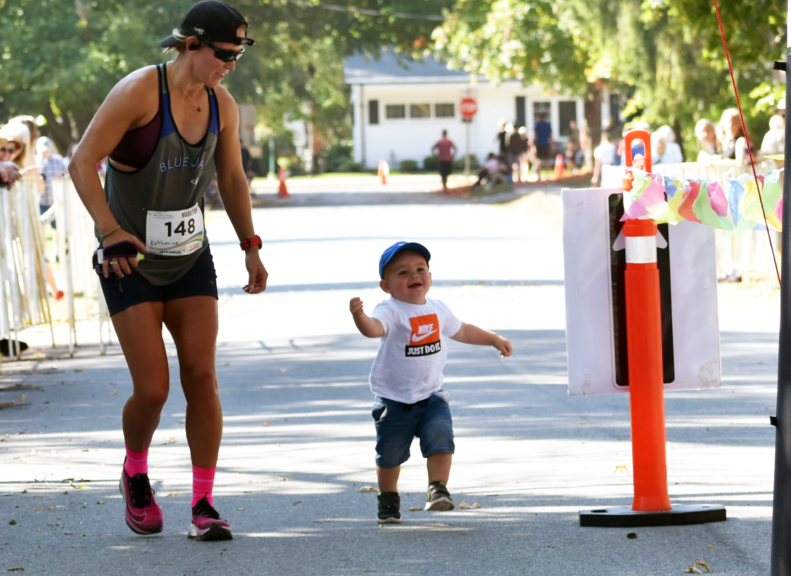 <p>2023 County Marathon Women’s event winner Katherine Shirriff and her biggest fan Connor Gunter cross the finish line at last year’s race. (Jason Parks/Gazette Staff)</p>
