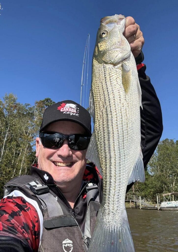 <p>County Kayak sport angler Bryan Morrow shows off a 23″ striped bass he caught taking part in an international fishing derby on Lake Murray, South Carolina. (Supplied Photo)</p>
