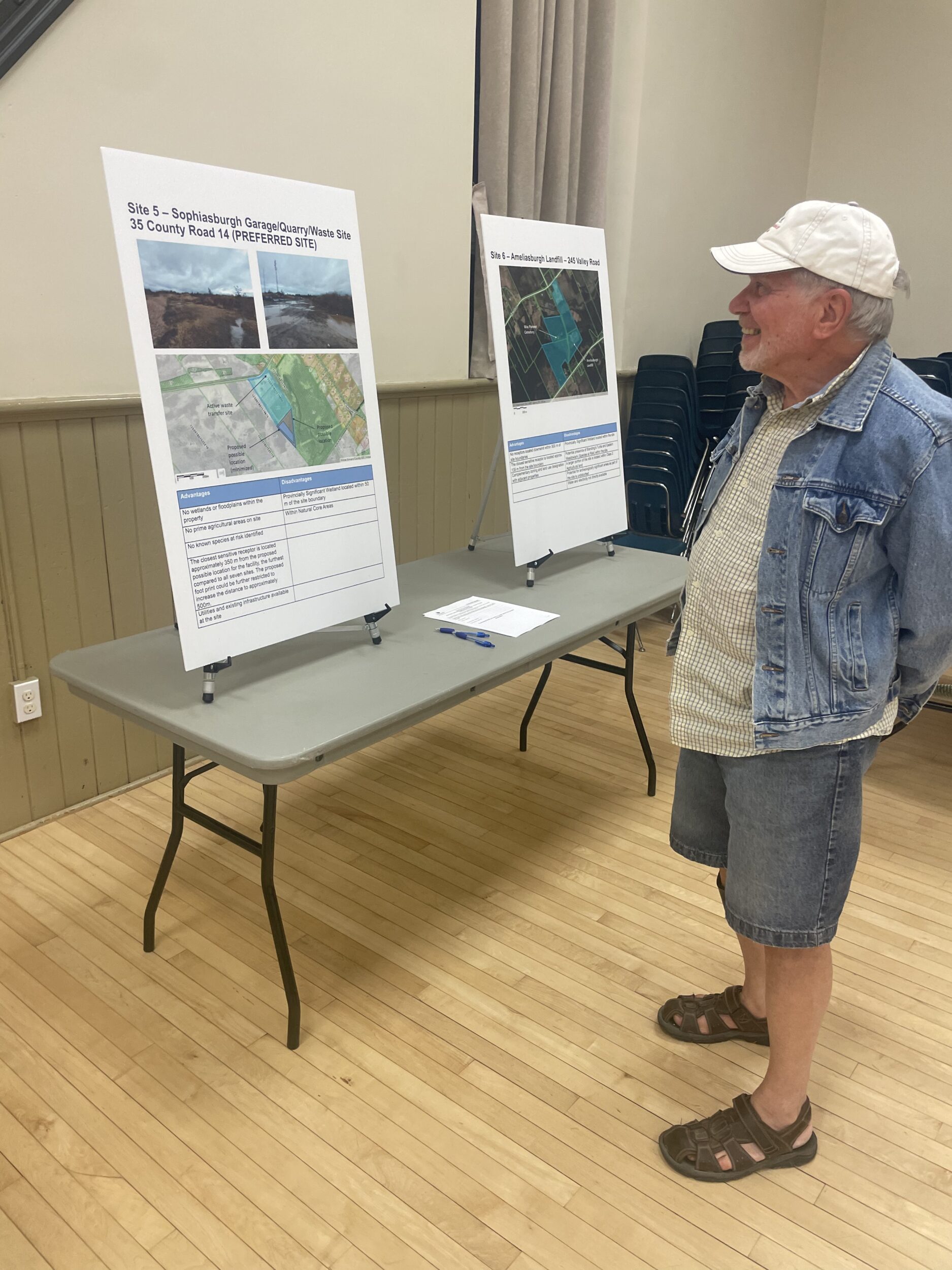 <p>A local resident examines an information board at Sophiasburgh Town Hall. Prince Edward County is examining the feasibility of starting a municipal compost program. (Eleanor Zichy/Local Journalism Initiative Reporter)</p>
