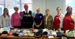 <p>Left to right: OPP Constable Lori Josephson, Rosemary Moore (volunteer knitter); OPP Staff Sergeant John Hatch, Barb Sills (OPP Keep Kids Warm Volunteer); Linda Jenkins (volunteer knitter); Cathy Lemkow (Manager Craft Group), Liz Jones (Director, PECMH Auxiliary Fundraising Projects). (submitted image)</p>
