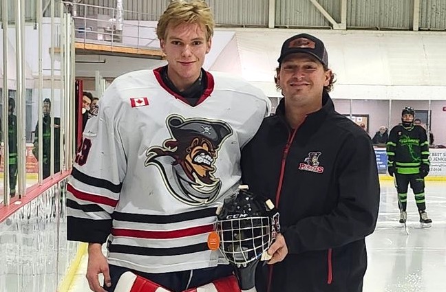 <p>Picton Pirates netminder Nolan Lane accepts a new goalie helmet from Custom Edge’s Chris Rice prior to Thursday’s game. Mr. Lane was the top goalie in the 63-team league in the month of November, post 7 wins, a 1.11 GAA and .965 save percentage. (Pirates Photo)</p>
