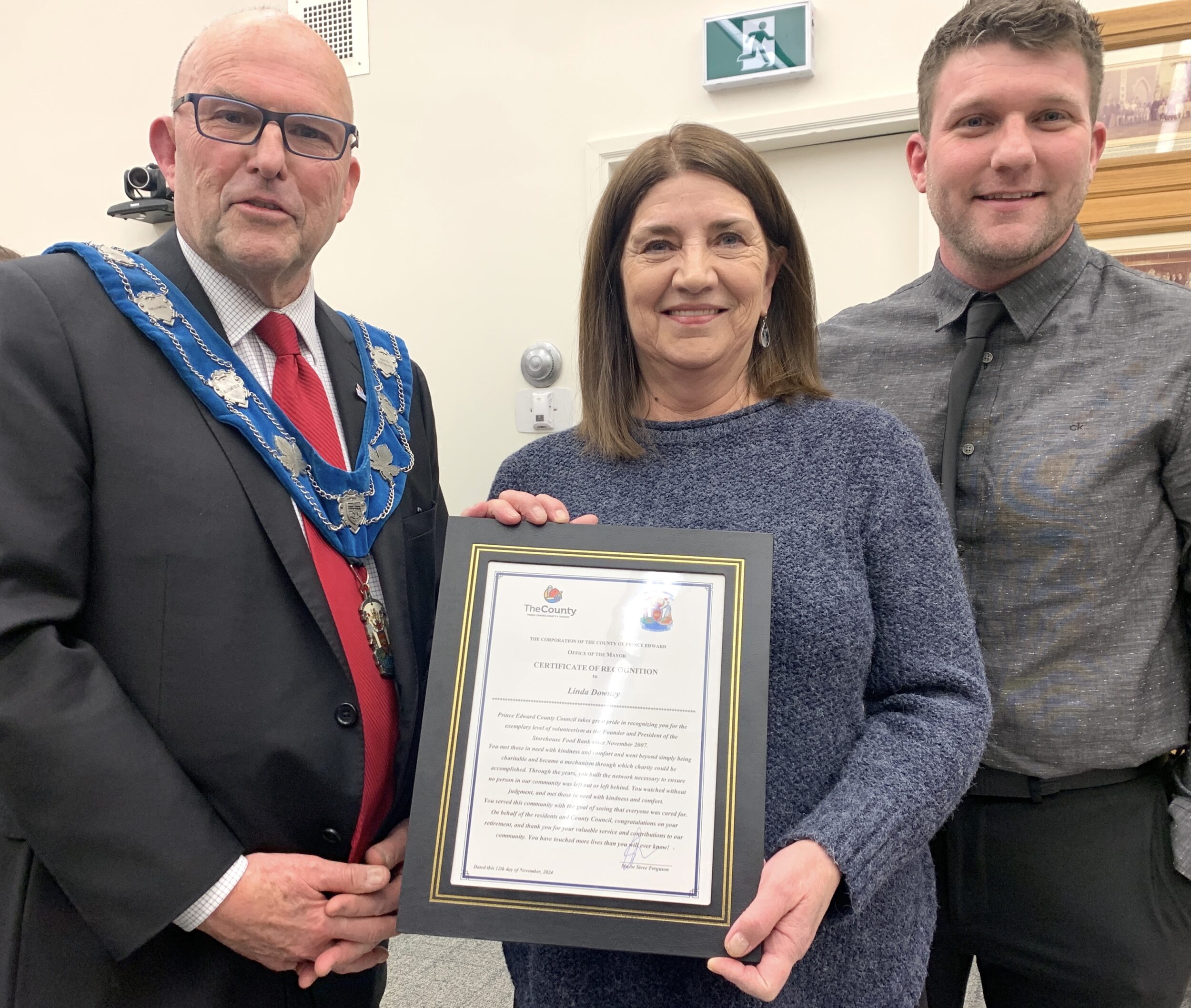 <p>Mayor Steve Ferguson and Councillor Corey Engelsdorfer present Storehouse Food Bank founder Linda Downey with a County of Prince Edward Civic Recognition Award. (Jason Parks/Gazette Staff)</p>
