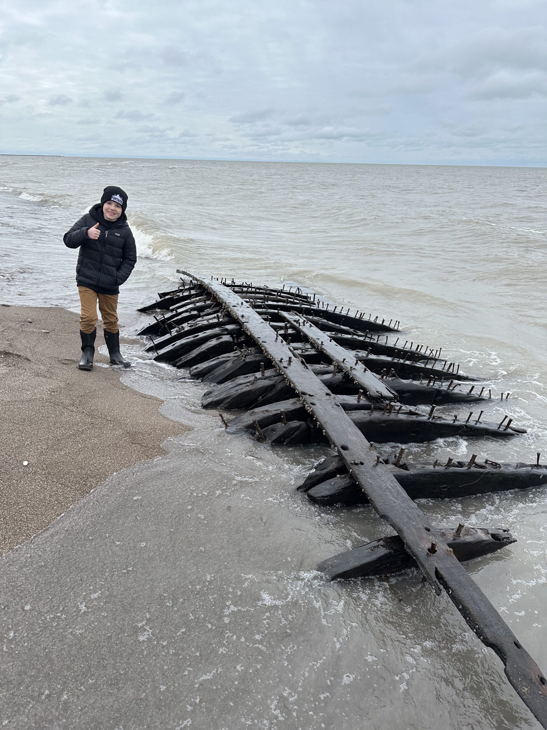 <p>Erieau’s Nolan Coburn with wreckage believed to be that of the paddlewheeler Picton which sank off Rondeau Point in 1882. (Submitted Photo)</p>
