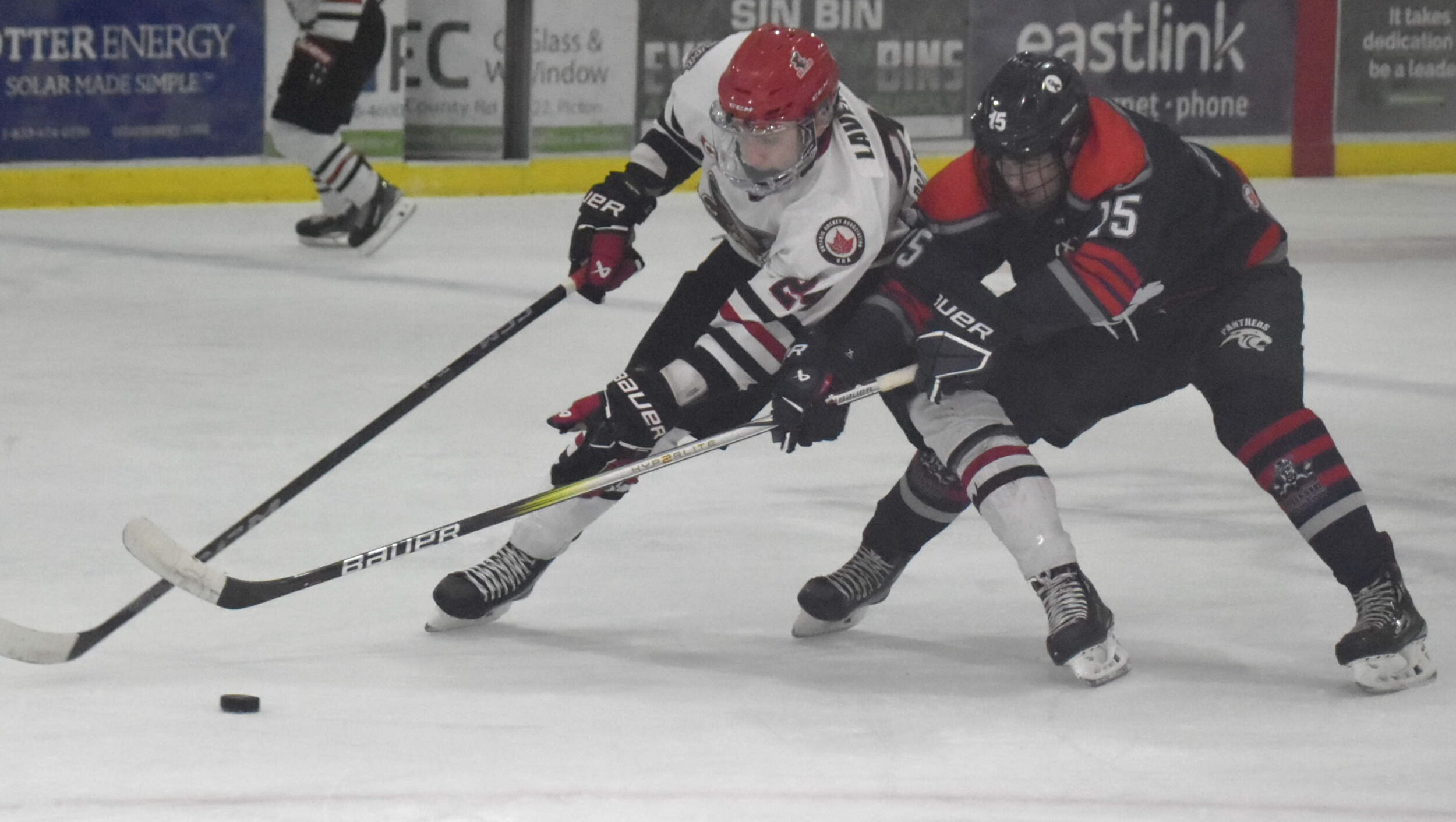 <p>Cole Lavender shields the puck from the clutches of Port Hope Panther Cole Harvey during Picton’s 7-2 win Thursday night. (Jason Parks/Gazette Staff)</p>
