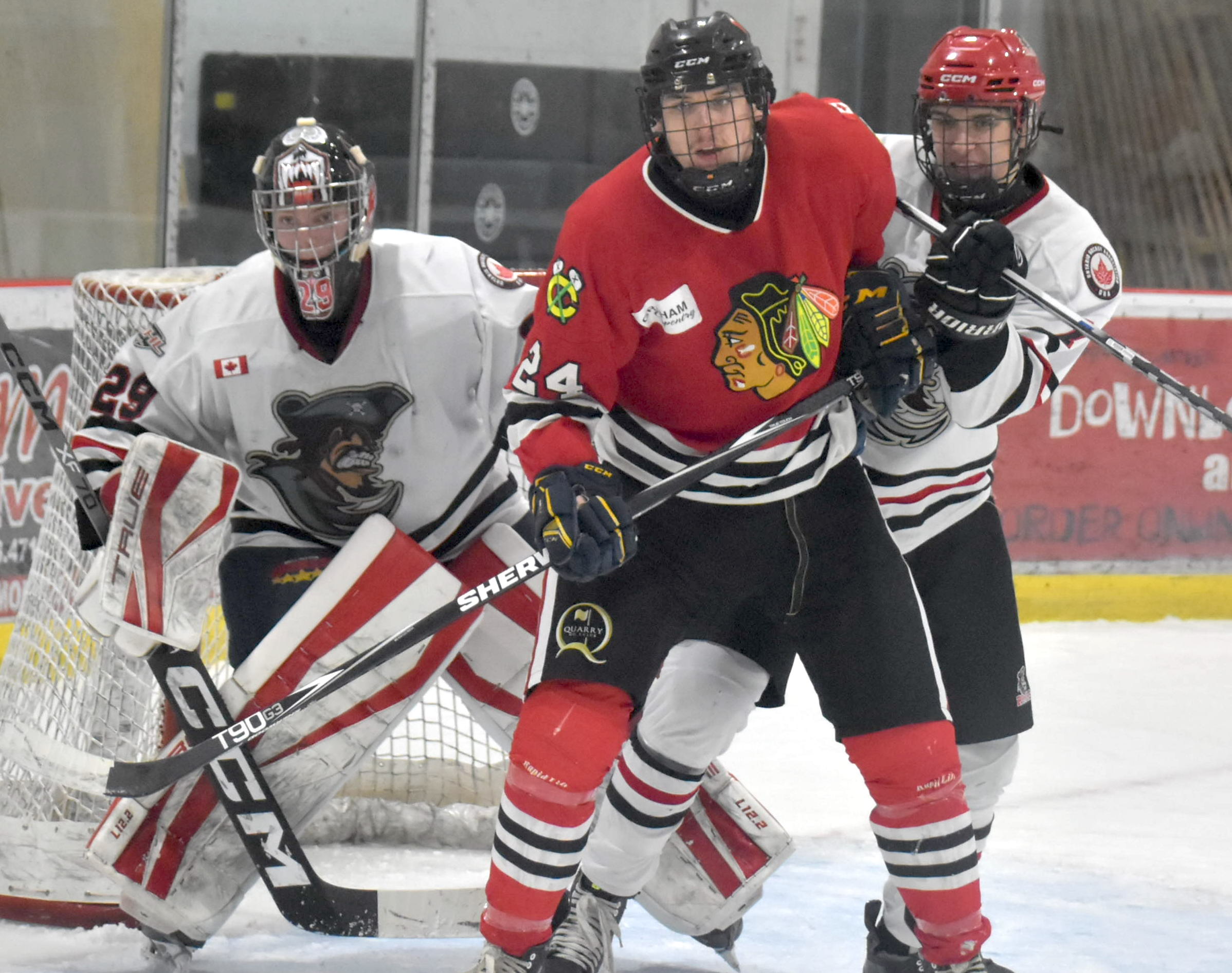 <p>Lakefield’s Gregg Sheedy makes life misrable for Picton netminder Nolan Lane and defenceman Will Potts. (Jason Parks/Gazette Staff)</p>
