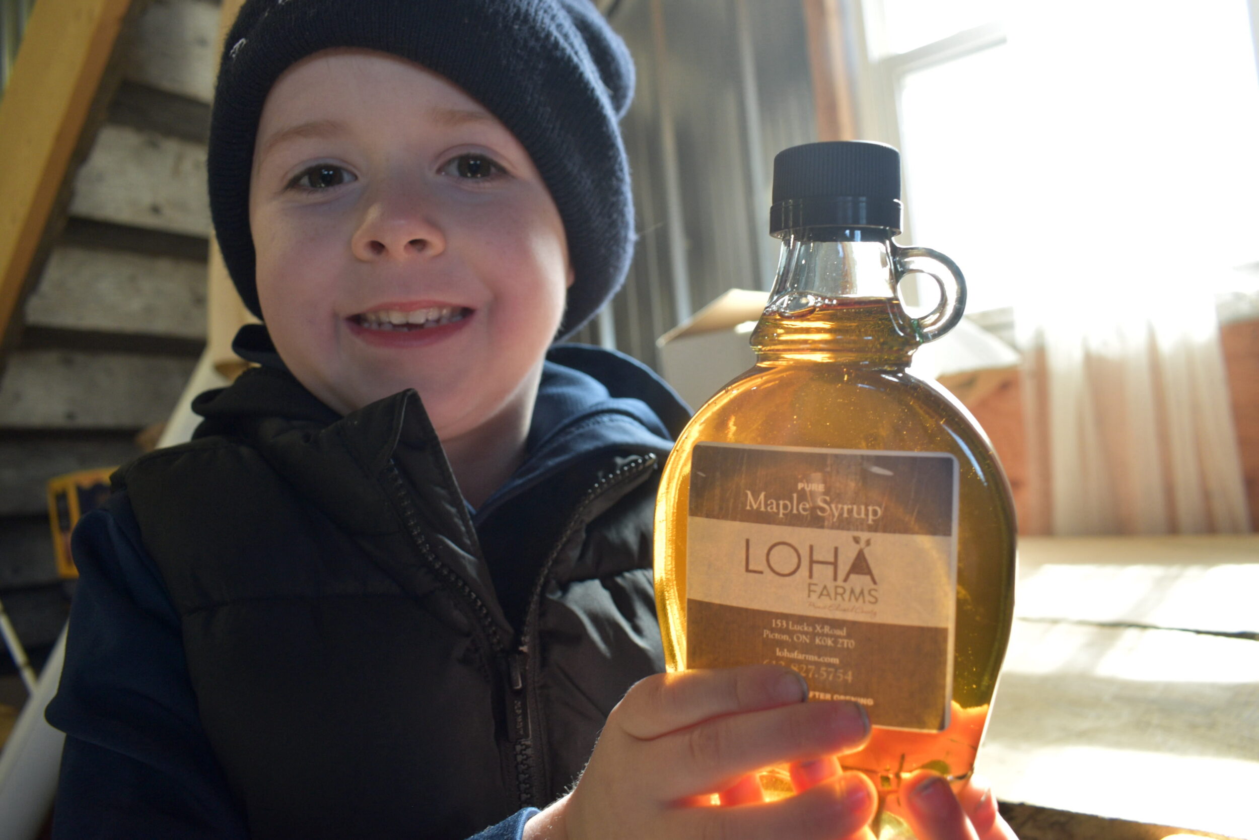 <p>Asher Armstrong, 5, shows off some maple syrup produced by LOHA Farms at the Maple In The County media day on Friday. (Jason Parks/Gazette Staff)</p>
