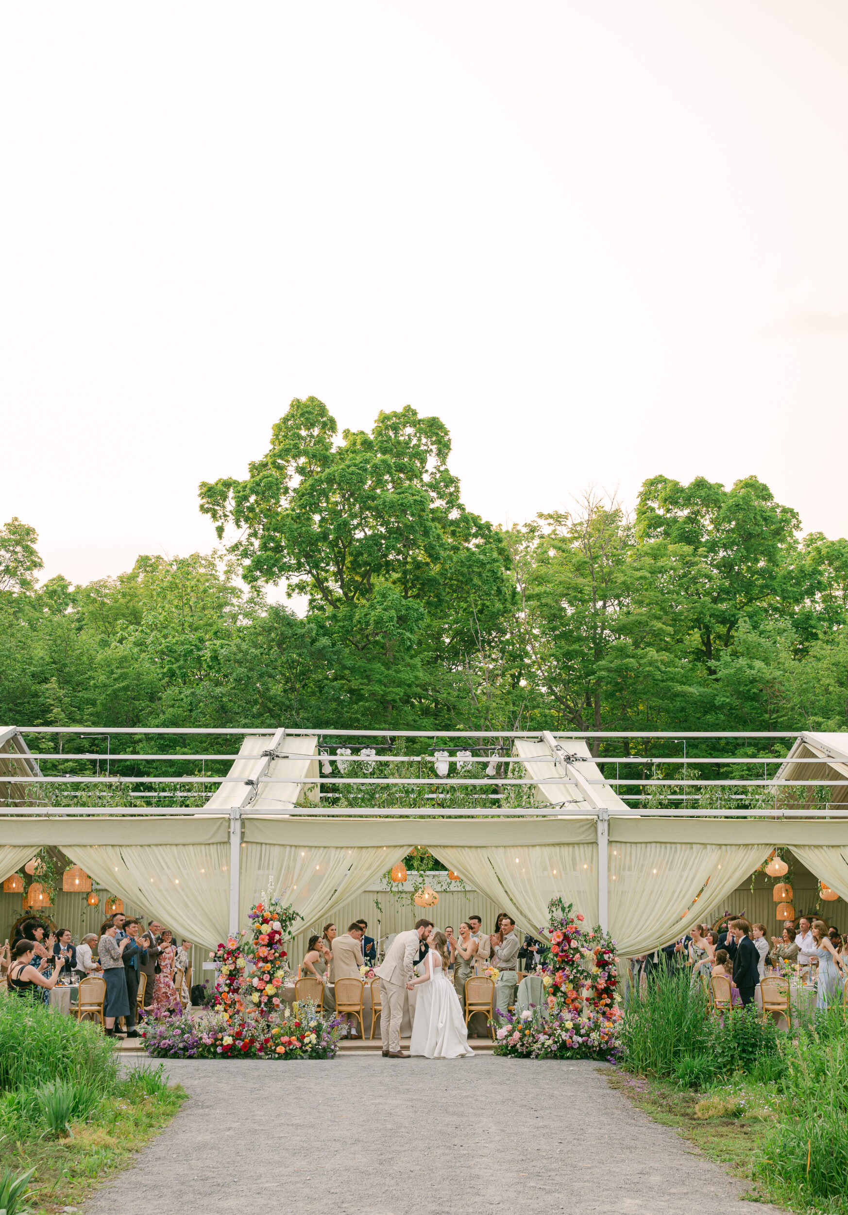 <p>A wedding that took place in June at Compass Rose Suites, planned by Ashley Pigott Events. Florals by Thalia Dahlia, light fixtures by Glamorous Affairs, and tent by Premier Tents. All those guests stayed at Compass Rose as well as at The Picton Harbour Inn, The Lakeside Motel, and The Royal Hotel. Dinner was catered by The Food Dudes, and the cake was by The Cookie Jar Bakery. The wedding was officiated by Brittany Shannon. (Photo: Tara McMullen)</p>
