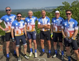 <p>The Team Myderwyk 2025: from left to right:<br />
Craig Wilson, Rob Garden, Gregor Stuart, Hans Myderwyk, Rob Legge, Chris Graham. Taken at the top of Clara’s Climb, after the Team had ridden 170 km.</p>

