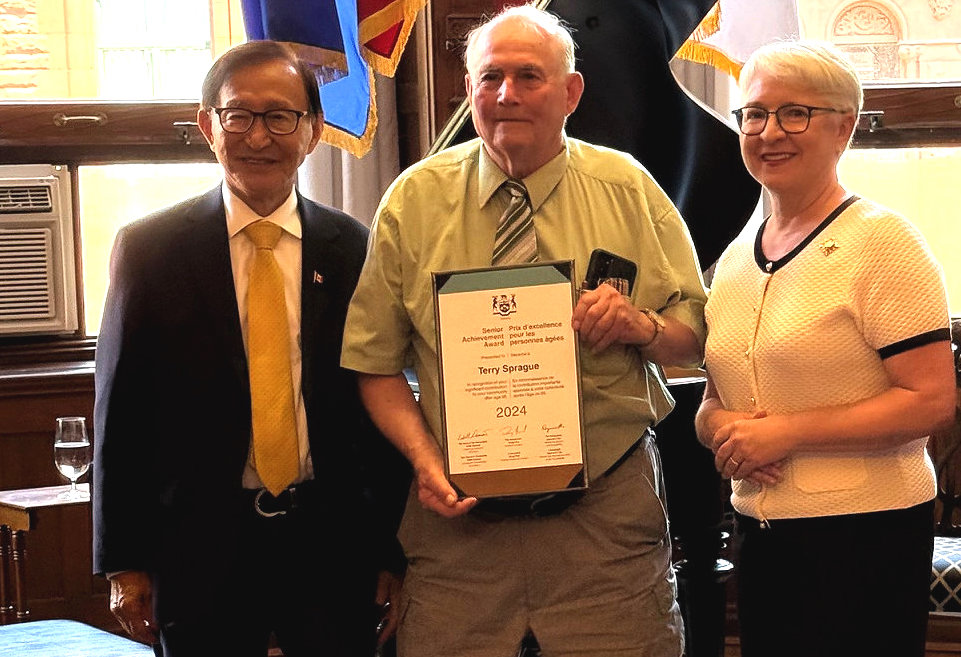 <p>Minister for Seniors and Accessibility Raymond Cho and Lieutenant Governor of Ontario Edith Dumont flank Terry Sprague at the Ontario Senior Achievement Awards program at Queen’s Park June 25. (Supplied Photo)</p>
