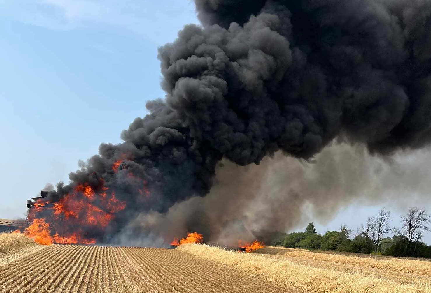 <p>A combine caught fire near the County Road 1/Highway 62 intersection on Monday afternoon. (Supplied Photo)</p>
