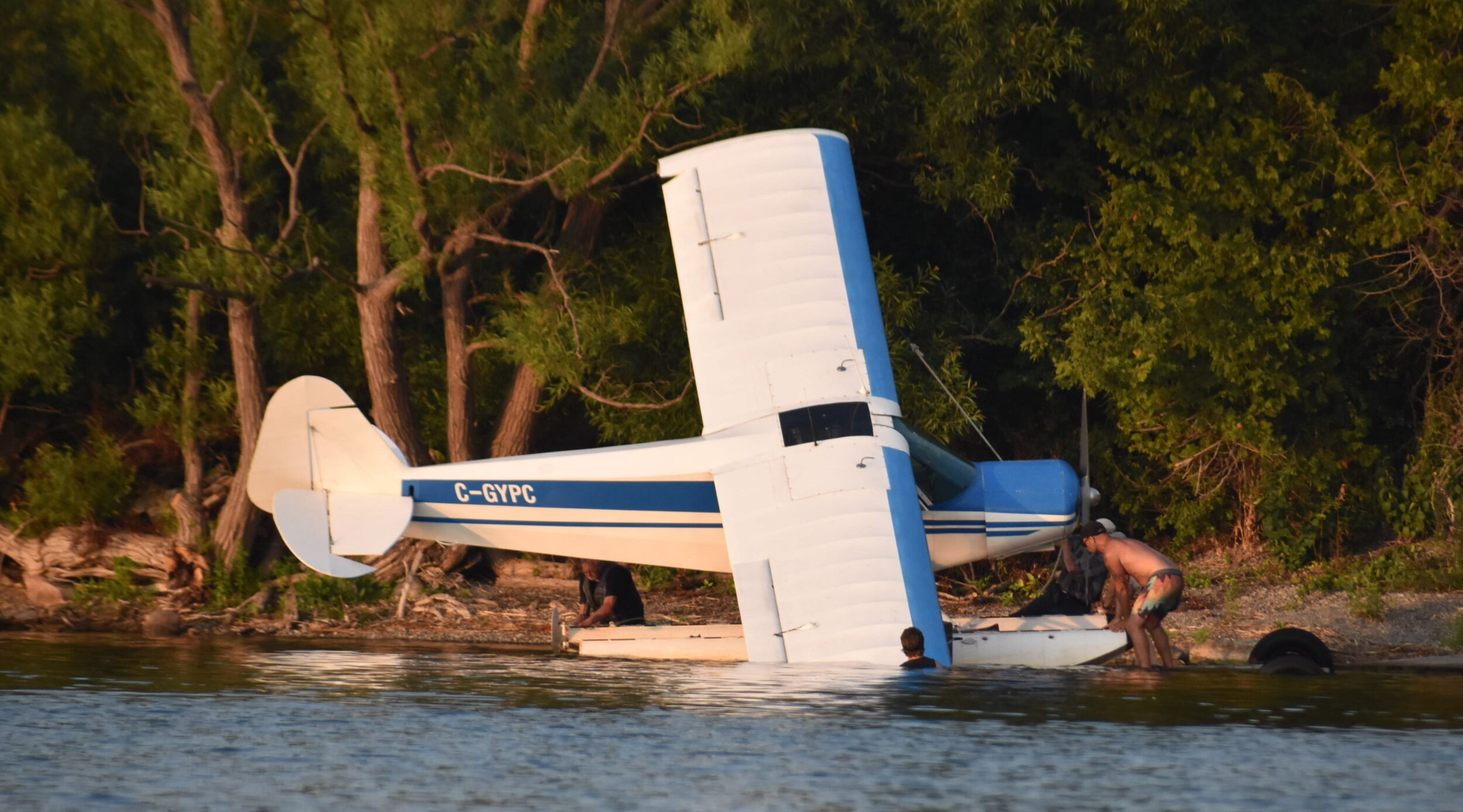 <p>A crumpled float plane is removed from East Lake Wednesday evening. (Jason Parks/Gazette Staff)</p>
