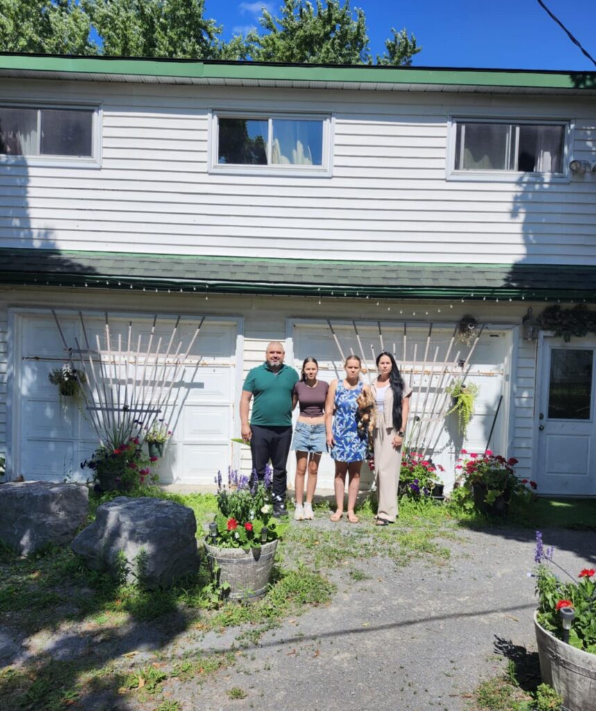 <p>The Nesterenko family in front of the house they rent near Picton Terminals.<br />
(Submitted Image)</p>
