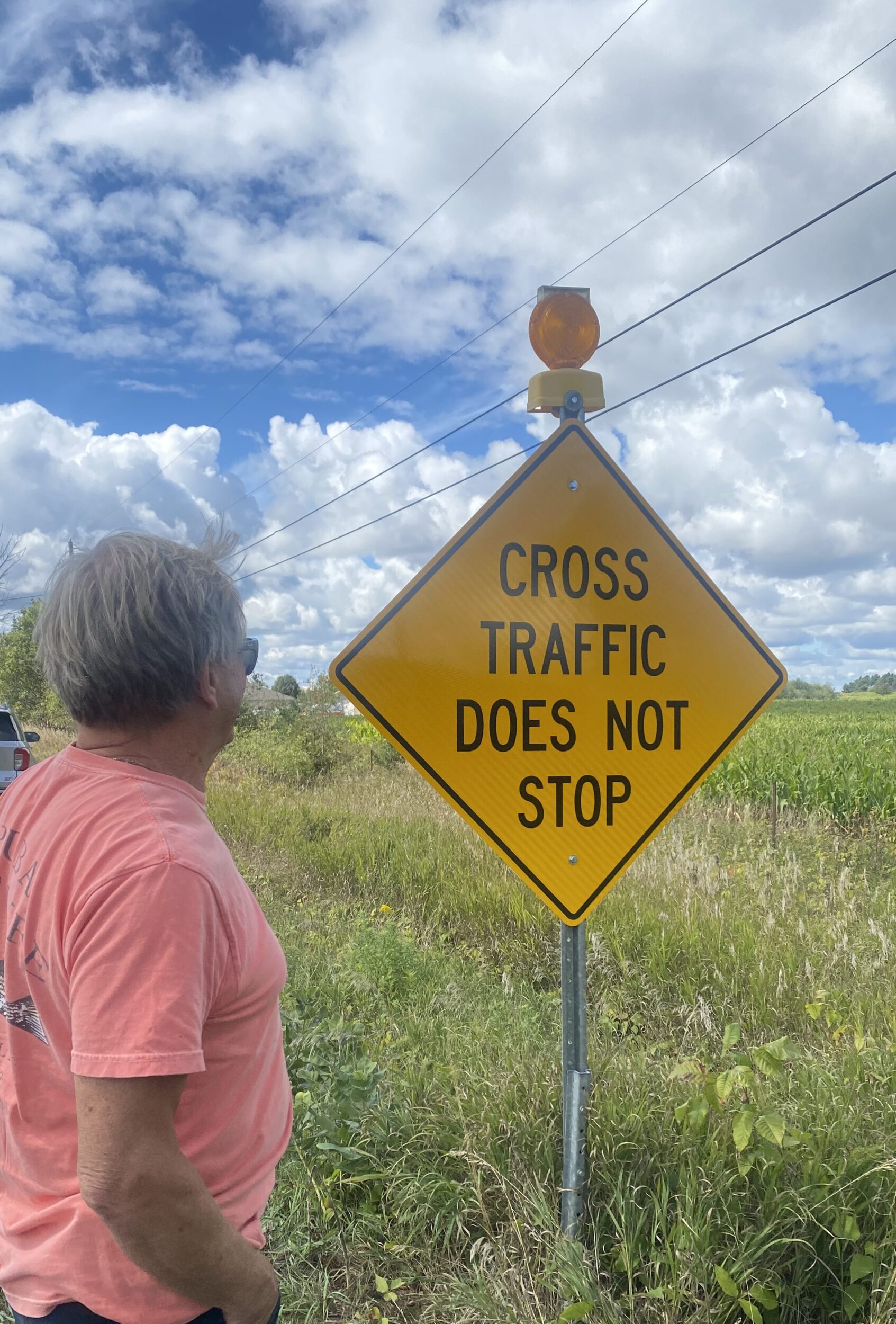 <p>Volunteer firefighter David Fox admires one of the new warning signs at 62 and 1 (Photo: David Fox)</p>
