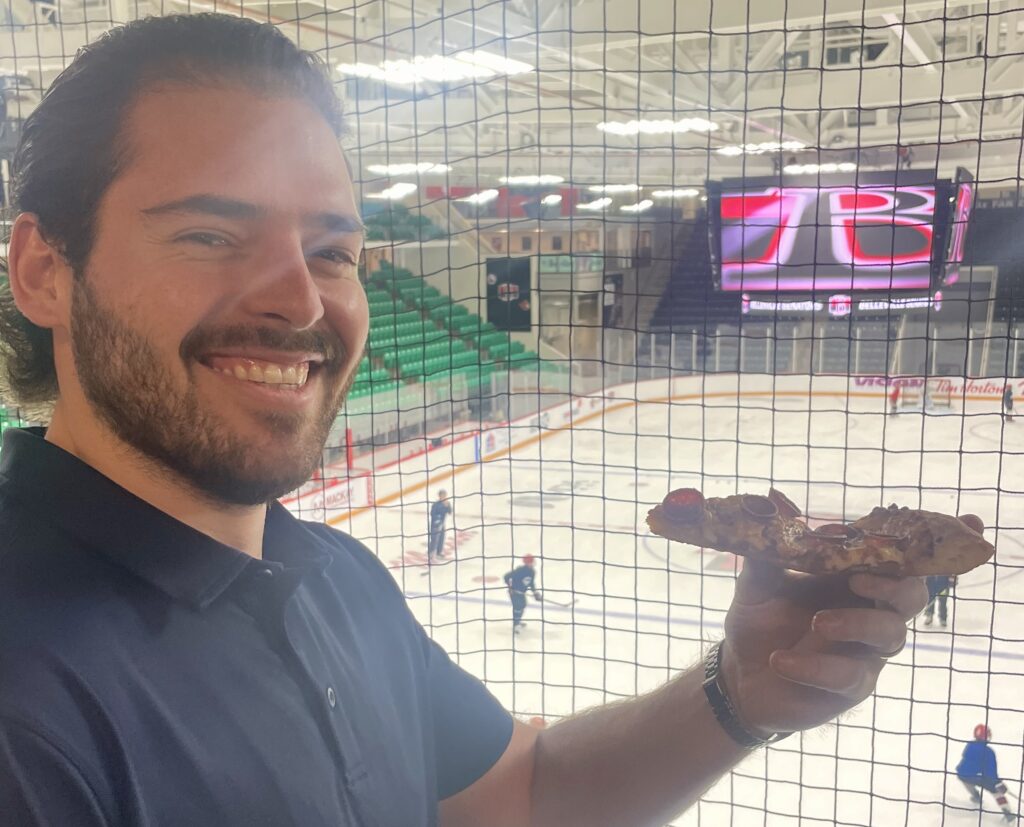 <p>Belleville Senators captain Garrett Pilon tries some fresh Gabriel’s Pizza at the club’s season preview event at CAA Arena October 1. (Jason Parks/Gazette Staff)</p>
