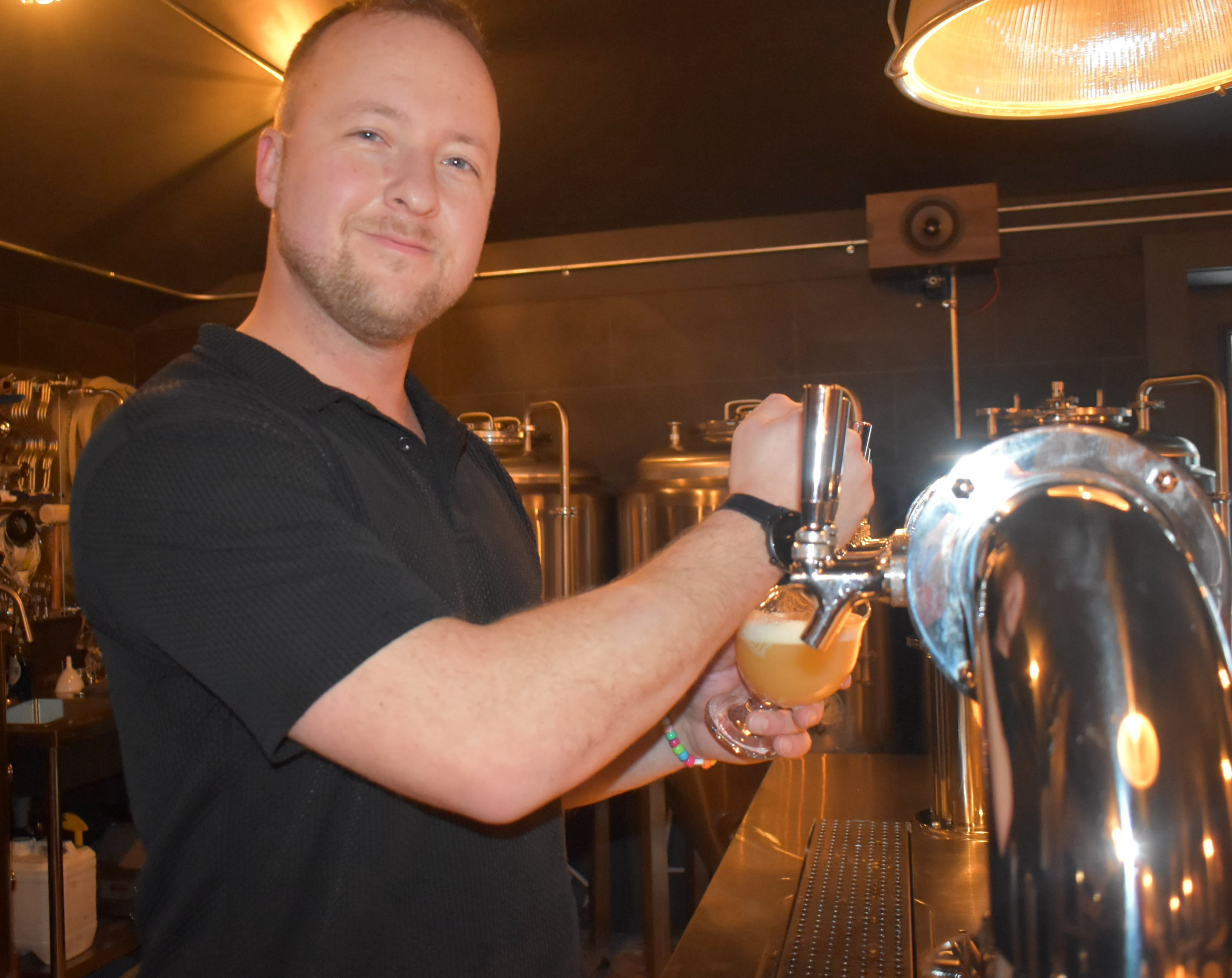 <p>Manager Andrew Weppler staffs the taps at The Outpost. (Jason Parks/Gazette Staff)</p>
