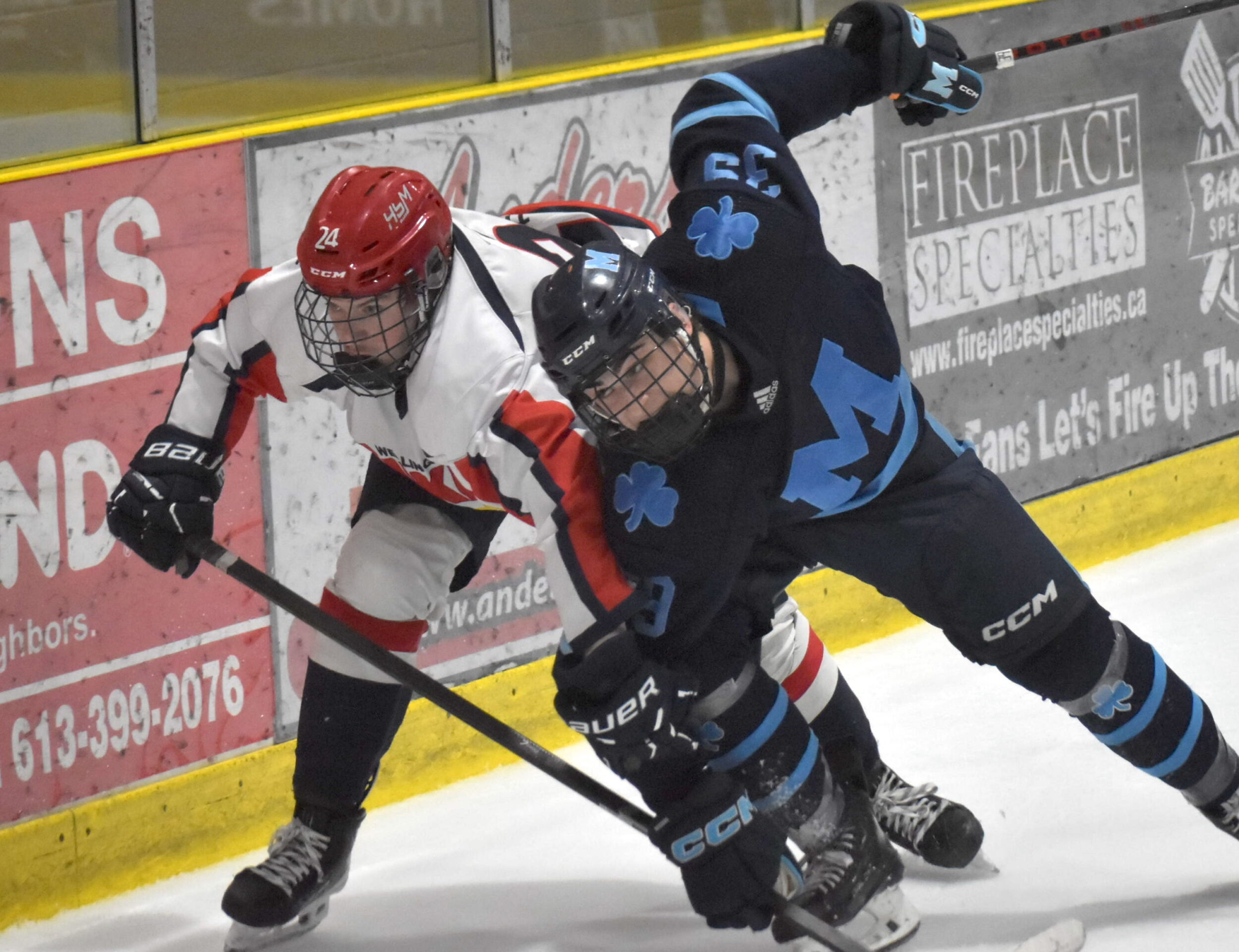 <p>Wellington’s Cole Ellis and St. Mike’s Josh Mandarino jockey for position in the corner during Tuesday night’s 6-2 win for the Dukes. (Jason Parks/Gazette Staff)</p>
