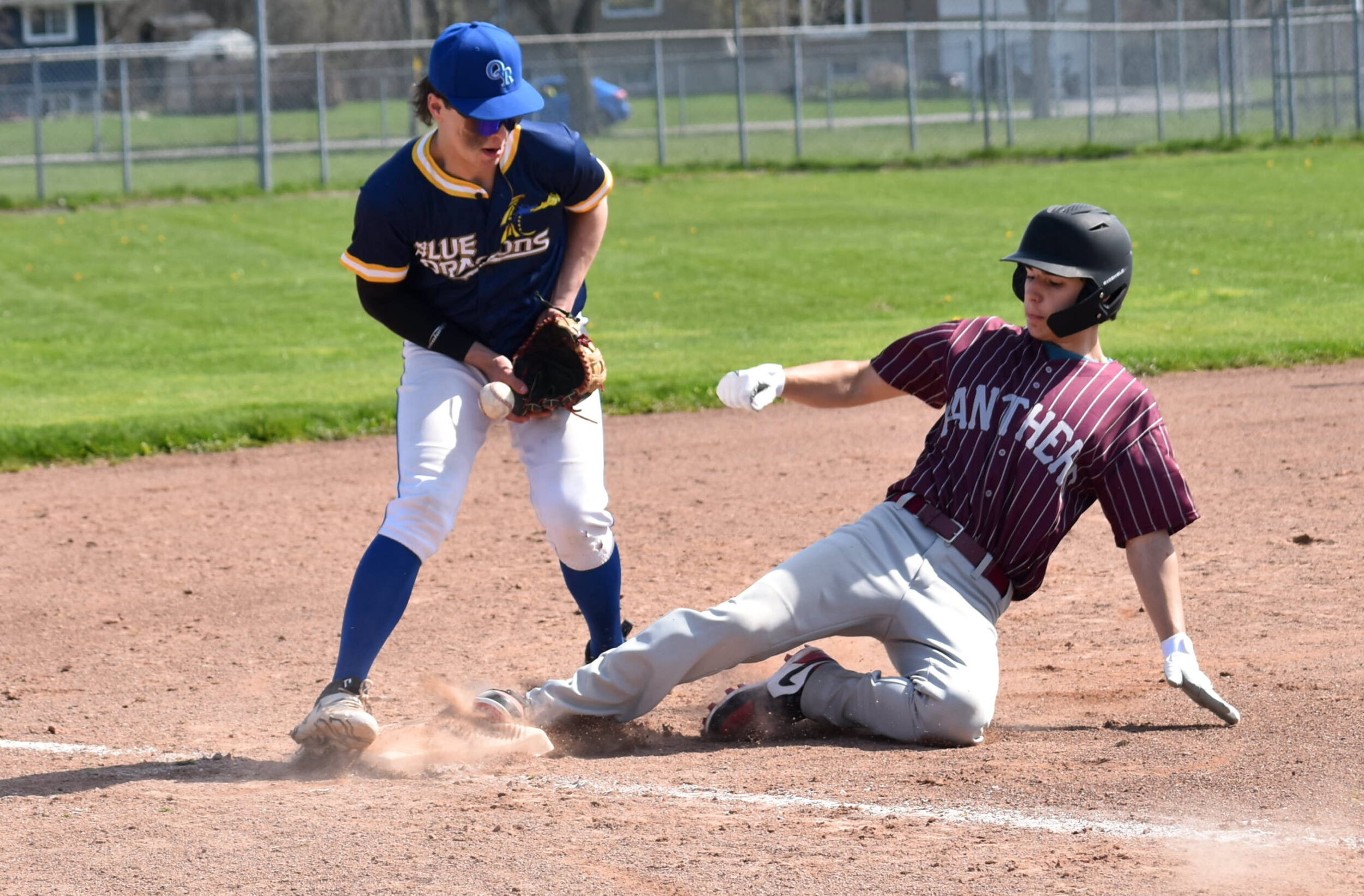 <p>PECI’s Colin Girvan slides safely into third while Reese Deline of East Northumberland Secondary School tries to control an errant throw during the Panther’s 5-2 over the Blue Dragons Monday afternoon. (Jason Parks/Gazette Staff)</p>
