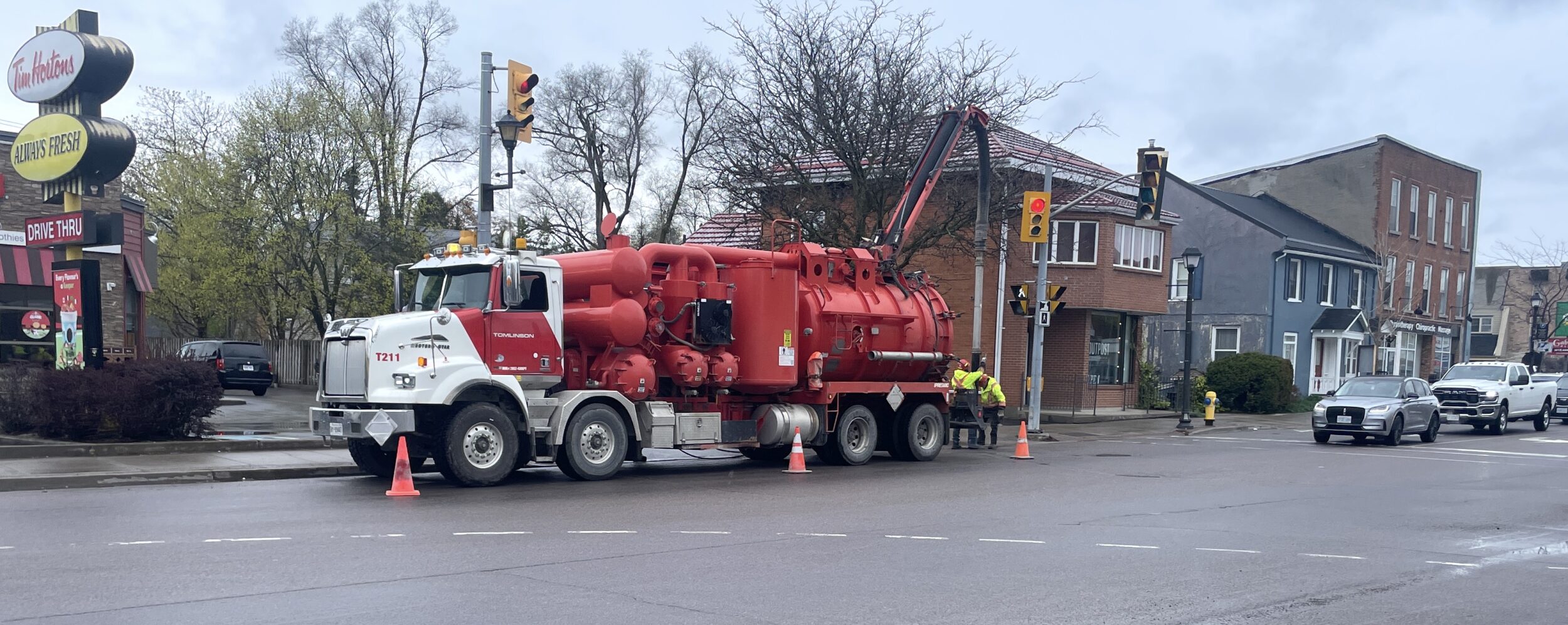 <p>Workers on Main Street deploy a hose attached to a vacuum truck to drain the storm sewers on Picton Main Street in relation to a reported fuel spill. (Jason Parks/Gazette Staff)</p>
