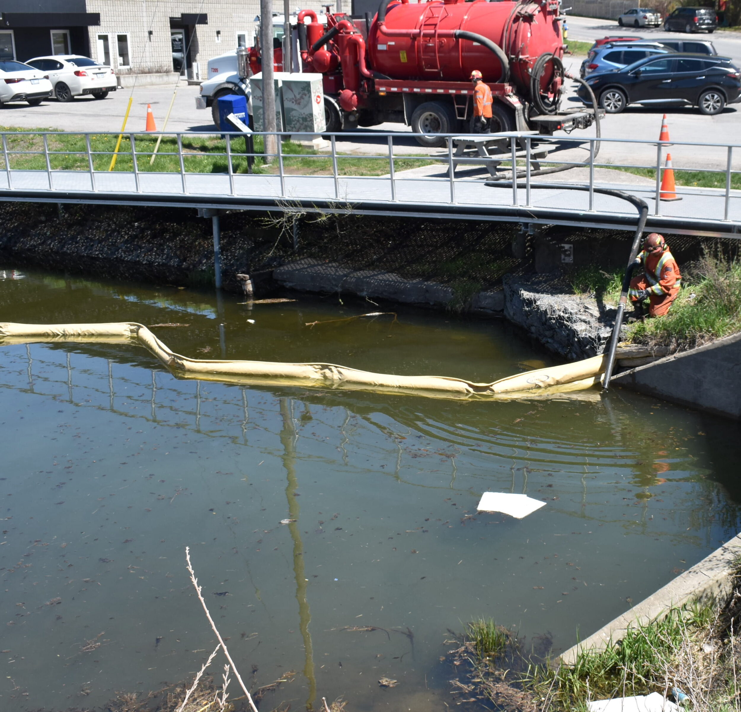 <p>Tomlinson Group Environmental Spill response workers deploy hoses to siphon off petrochemicals floating at the surface of the mouth of Marsh Creek. (Jason Parks/Gazette Staff)</p>
