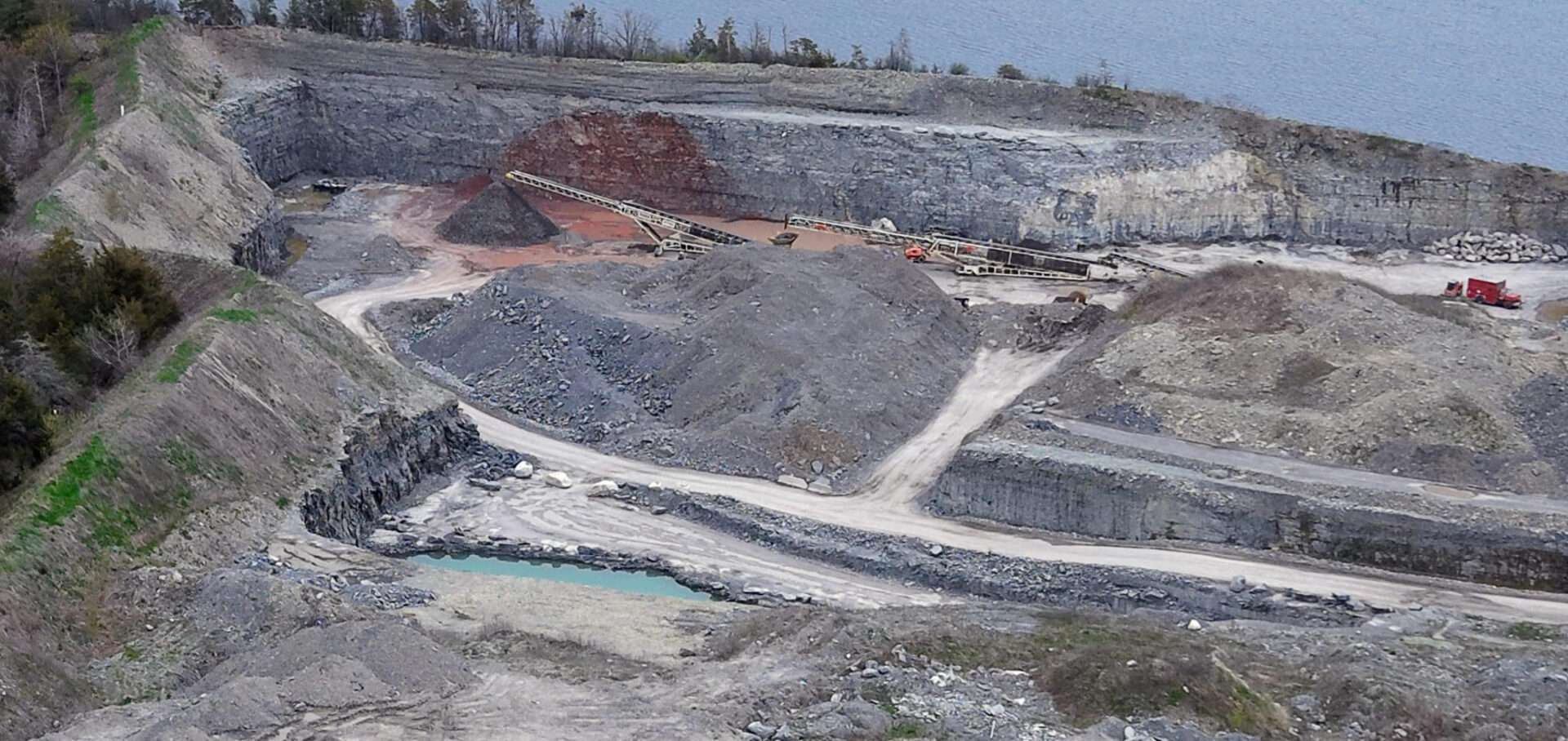 <p>Bauxite stored at the Sophiasburgh site leaves behind red rock and surface water five months after its removal. (Supplied Image)</p>
